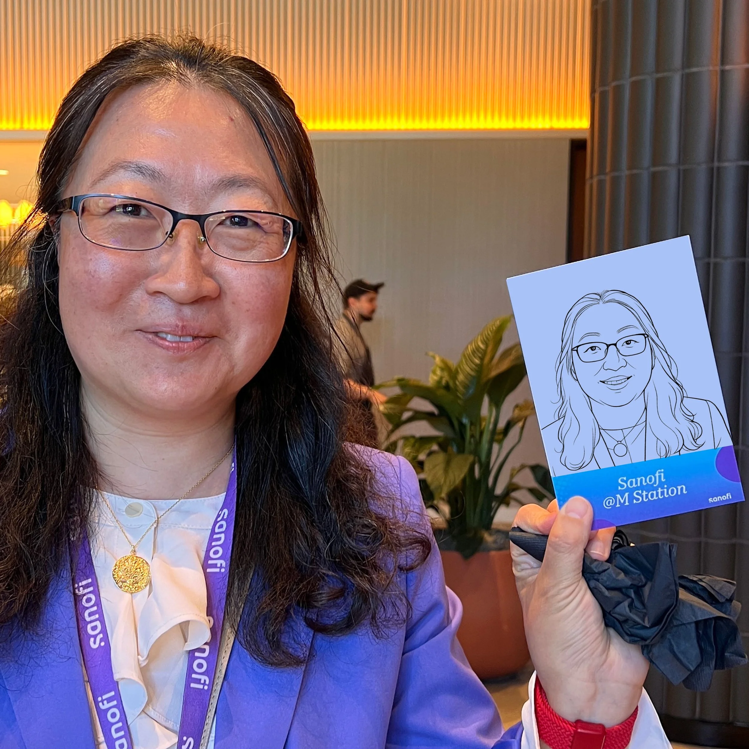 Woman showing off her robotic drawn portrait