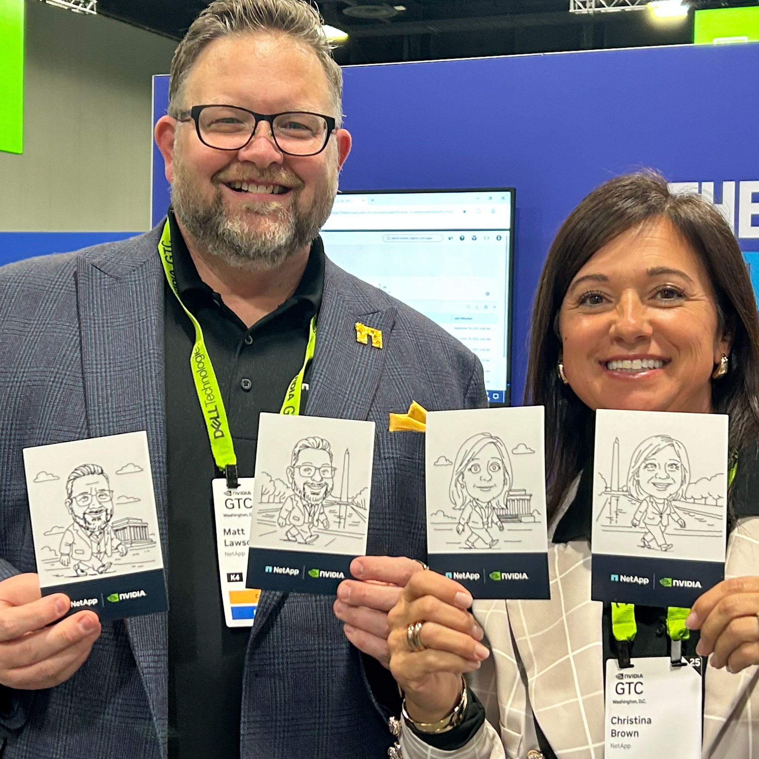 Two people holding up their sketches drawn by SketchBots