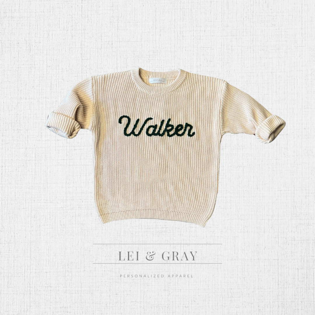Lettering (dark green) on a Sand sweater
