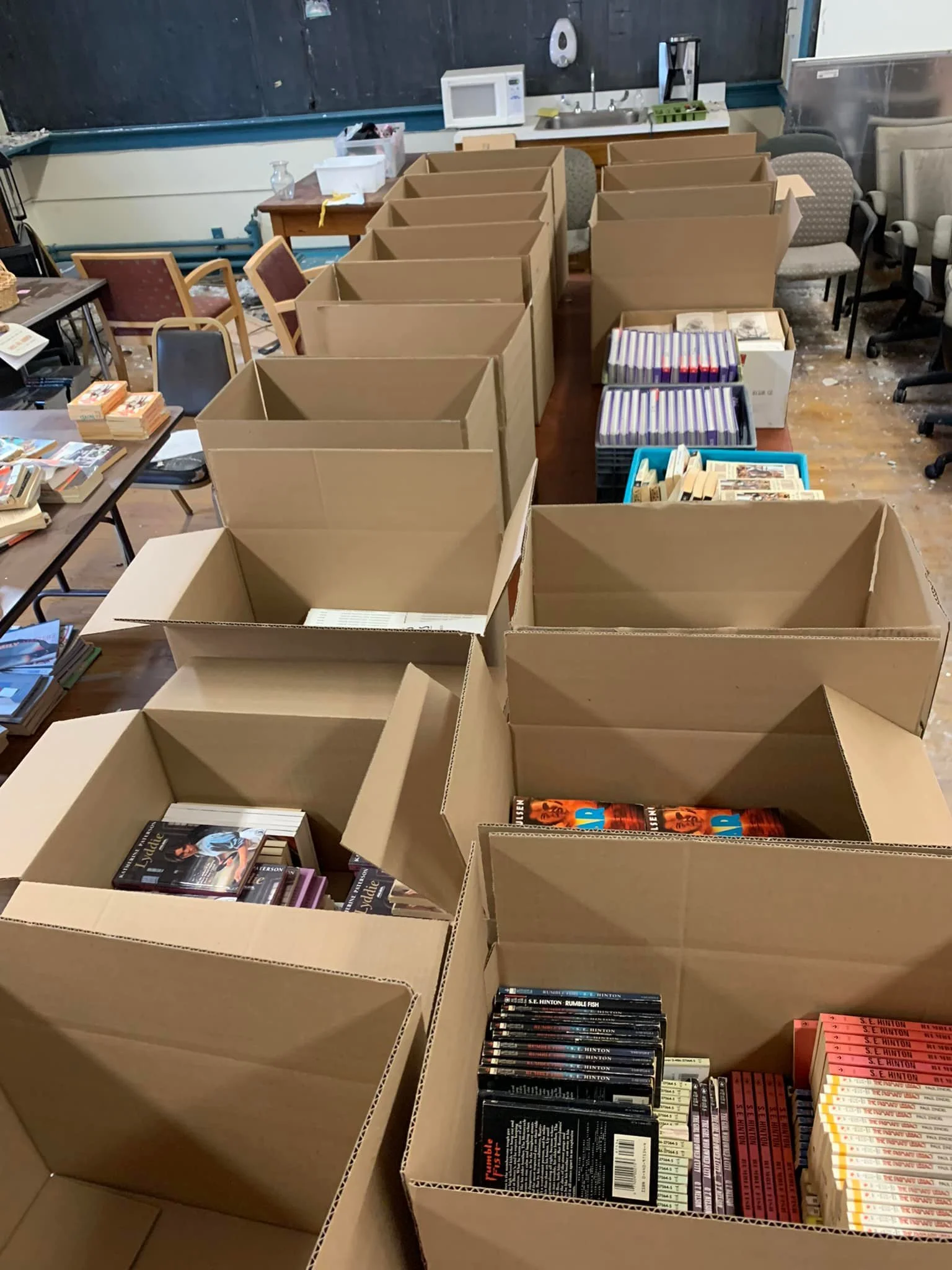 Boxes of books being organized and donated