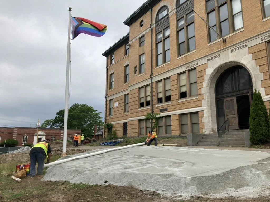Pride flag raised in front of the building