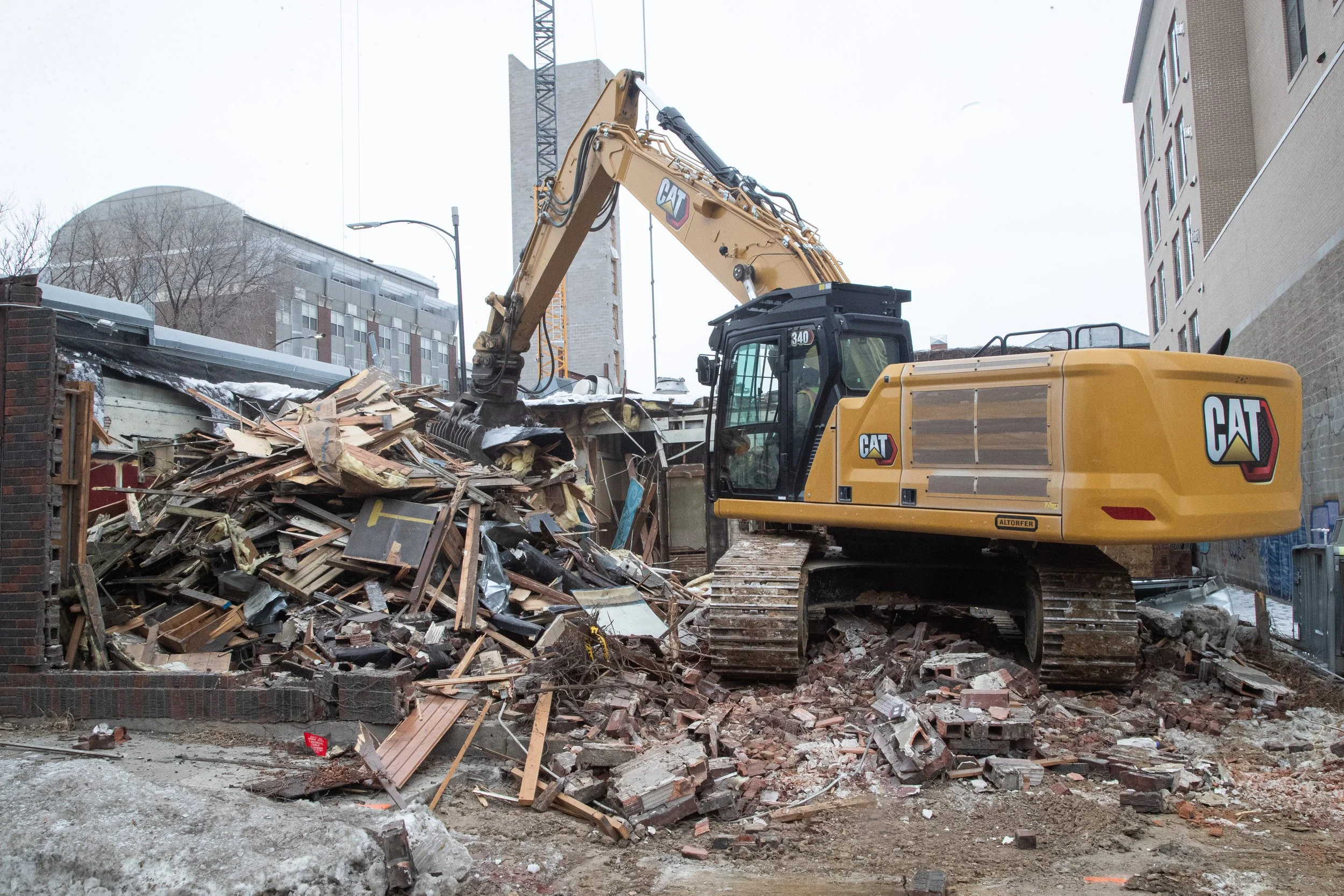 A bulldozer demolishes The Mill in Iowa City, Iowa on Jan. 27 2021. The Mill was known as an art and concert venue for Iowa City artists and musicians before closing in May 2020.