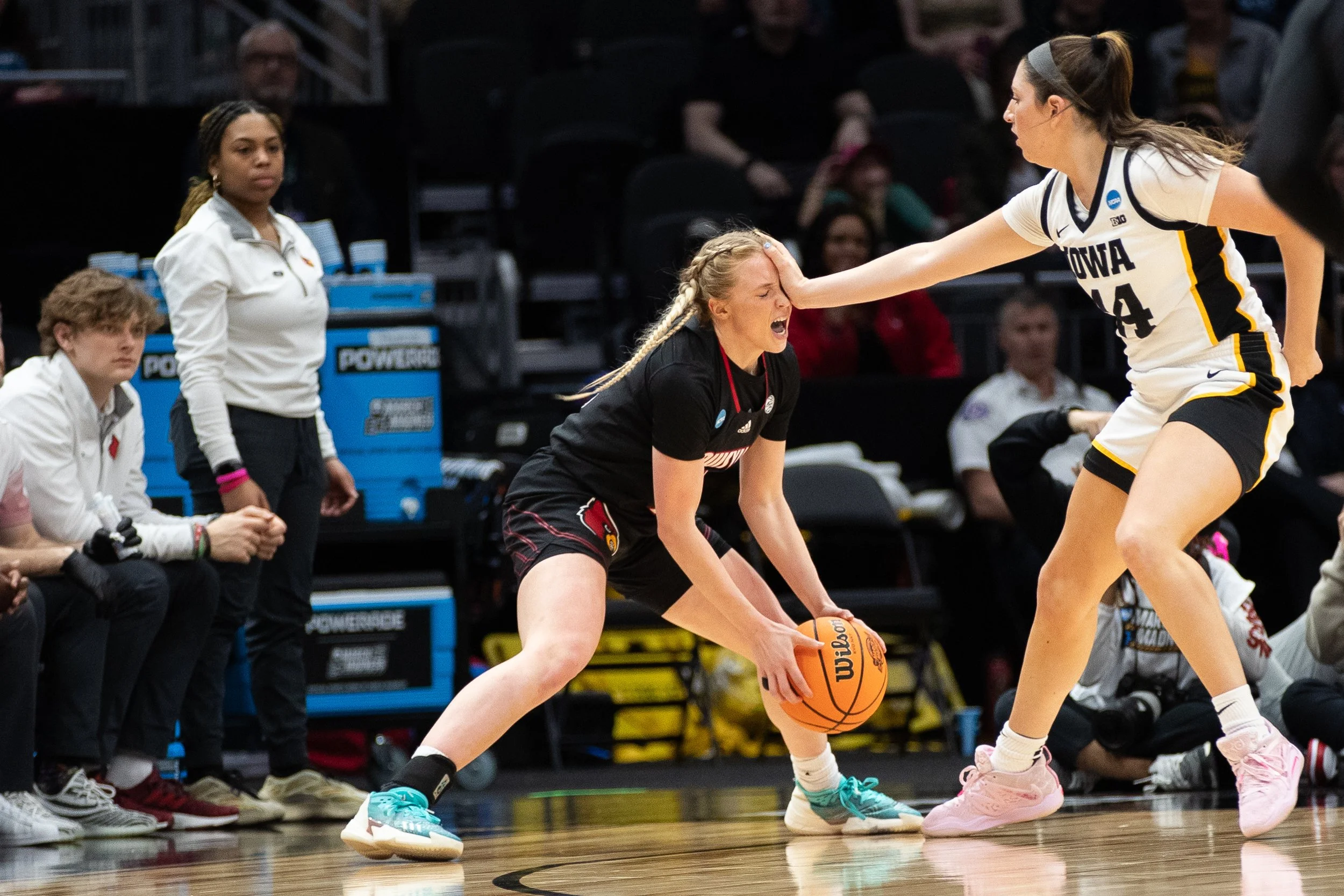 Iowa forward McKenna Warnock (right) stiff arms Louisville guard Hailey Van Lith (left) during a 2023 NCAA Elite Eight women’s basketball game between No.2 Iowa and No.5 Louisville at Climate Pledge Arena in Seattle, Washington on Sunday, March 25, 2