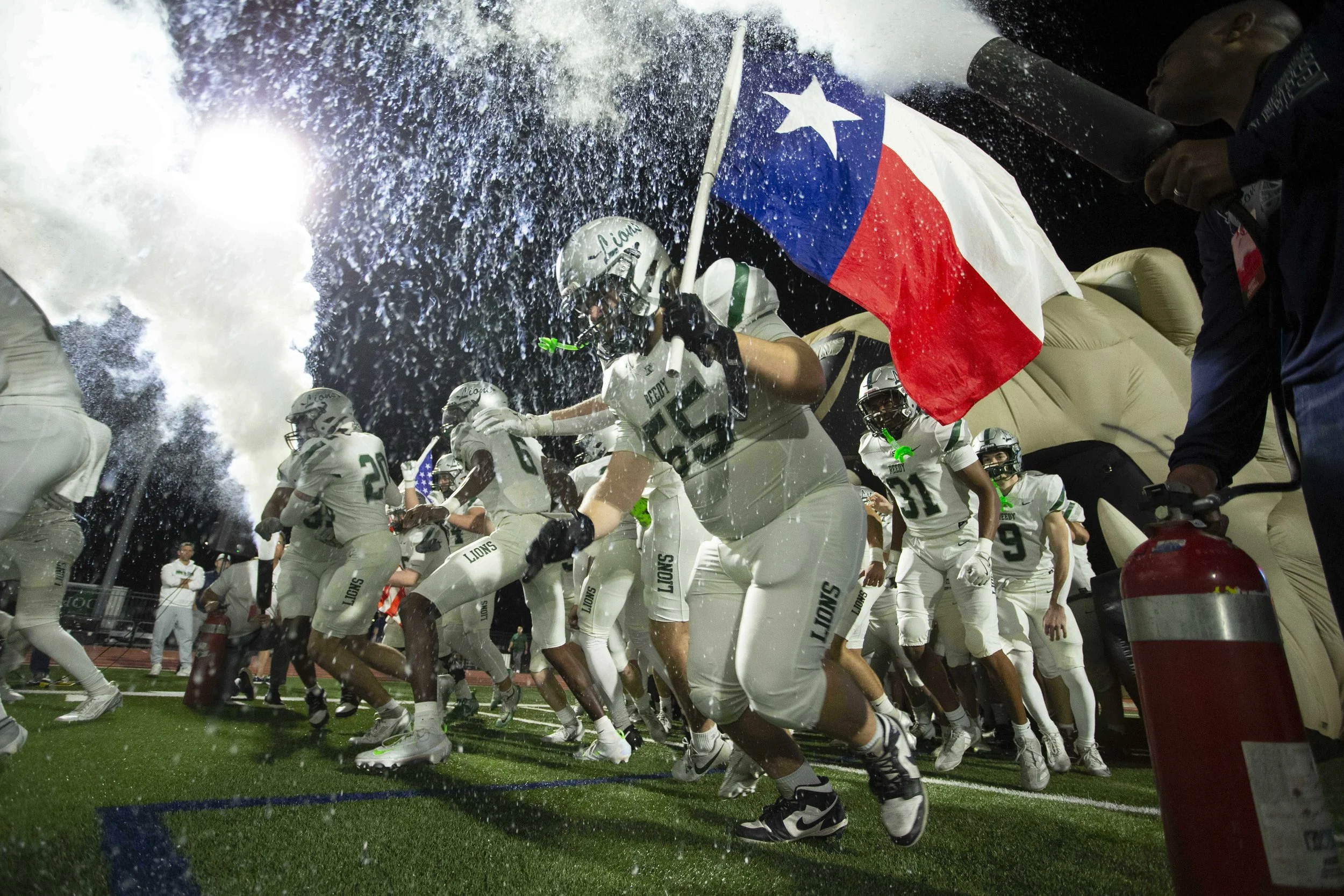 The Frisco Reedy Football team run outs before a bi-district playoff game against Creekview at Tommy Standridge Stadium in Carrollton, Texas on Friday, Nov. 13, 2025.