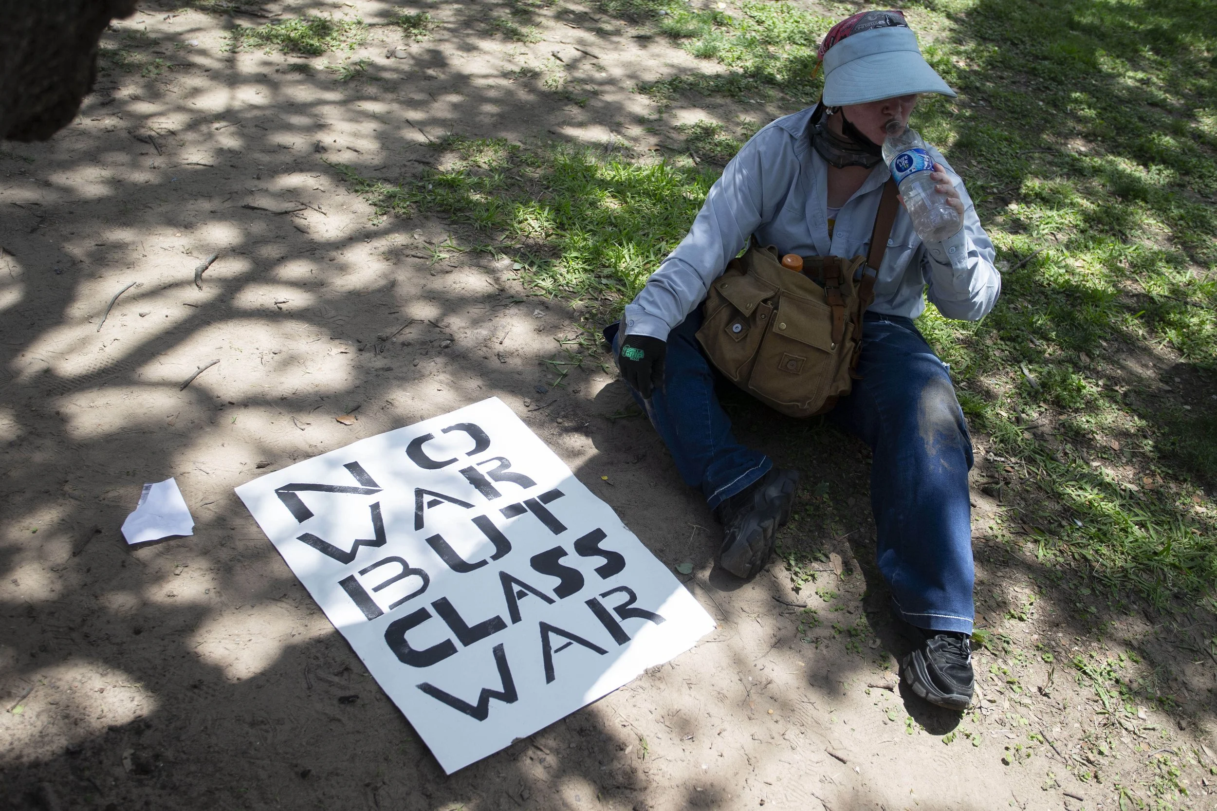 A protester takes a sip of water during the No Kings Protest at Akard Plaza in Dallas, Texas, on Saturday, June 14, 2025. (Daniel McGregor-Huyer)