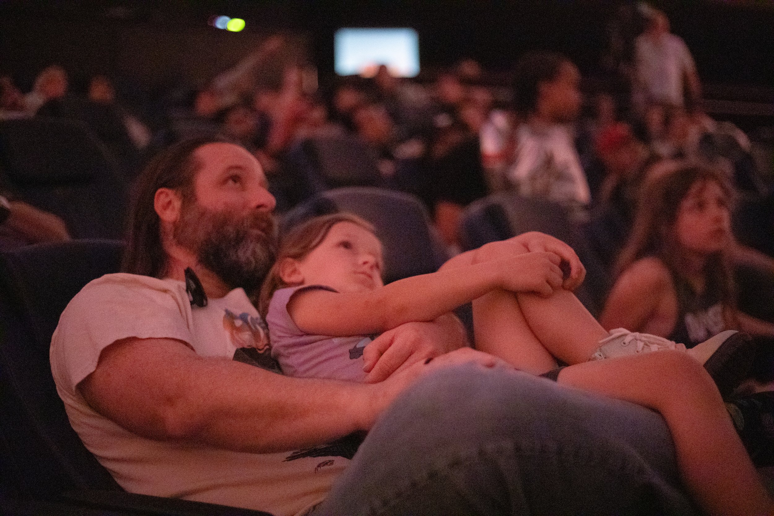 Tim Sneed and his daughter, Fern (age 11), watch the Artemis II return to earth during the Artemis II return watch party at the UTA Planetarium at the University of Texas at Arlington in Arlington, Texas. (Daniel McGregor-Huyer/Zuma Press Wire)