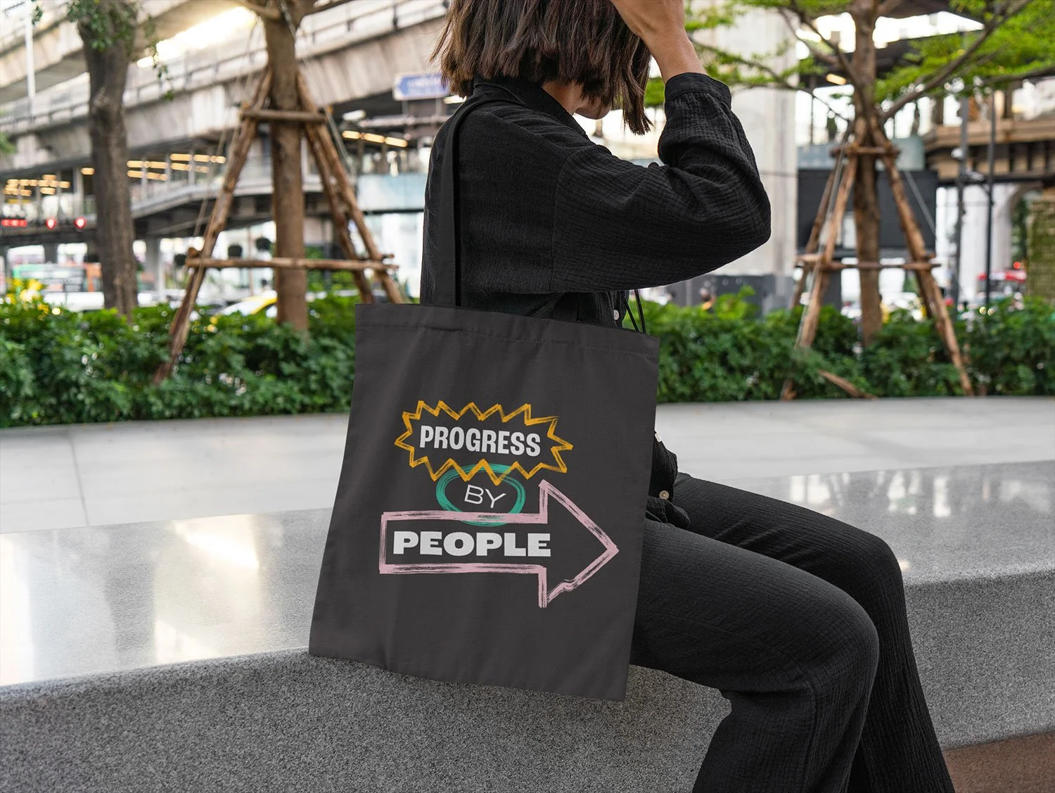 Progress by People tote bag hanging on woman's shoulder