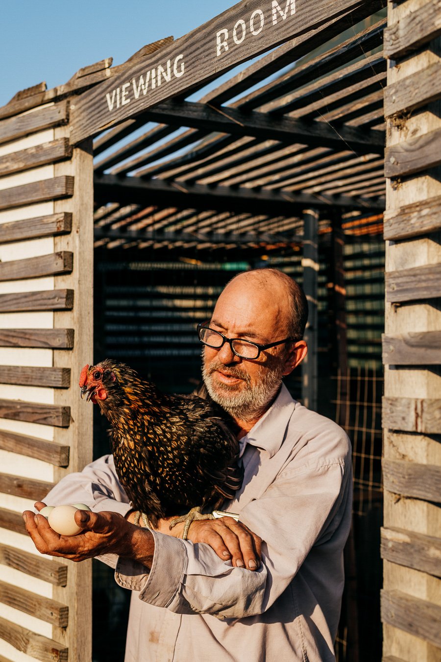 17 - a man holds a show chicken and eggs.jpg