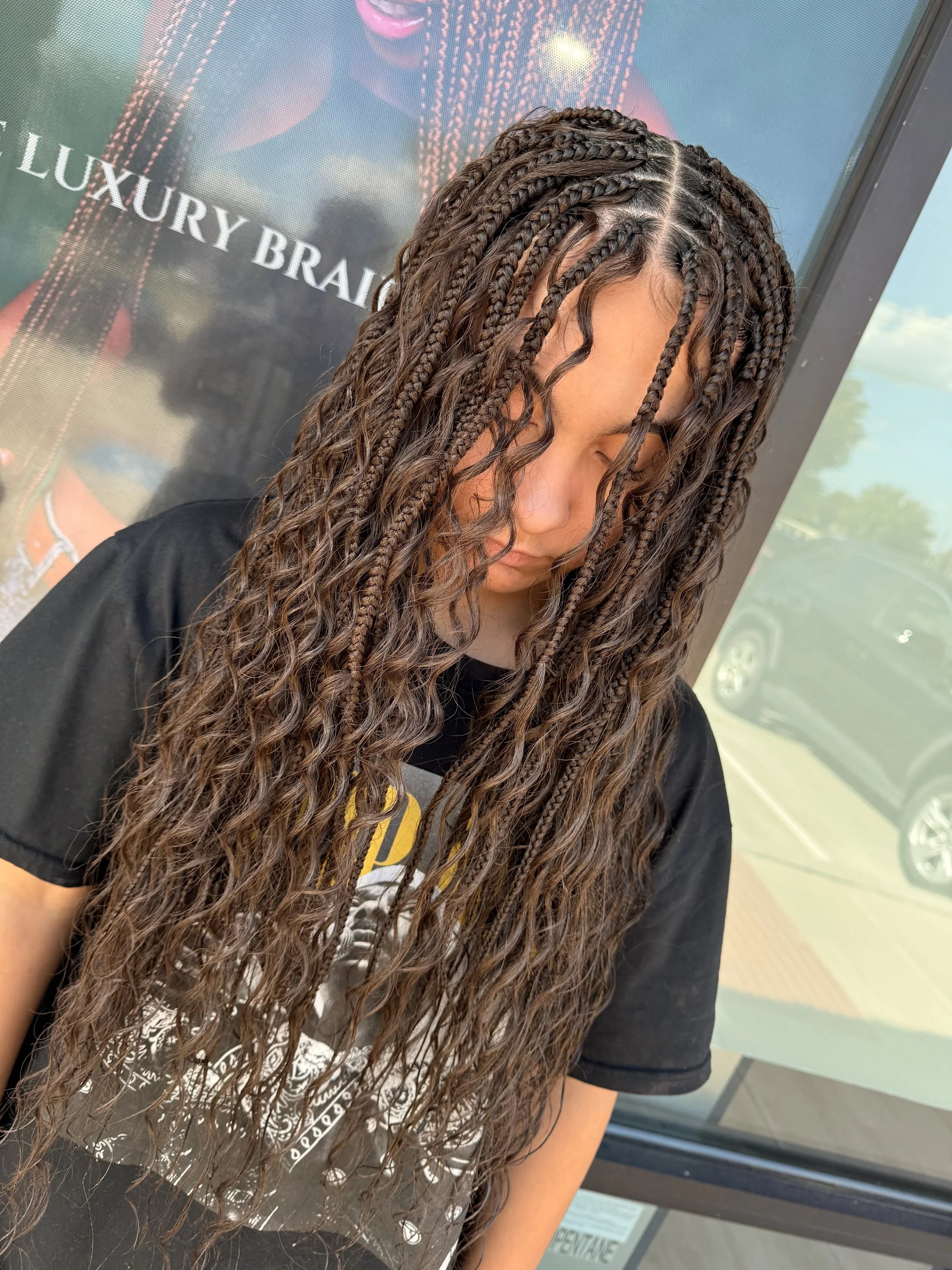 Woman wearing long brown boho braids with curly human hair at Legacy Braids in McKinney, TX