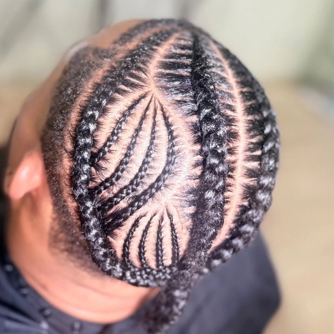 Men’s stitch braids with an intricate decorative scalp design