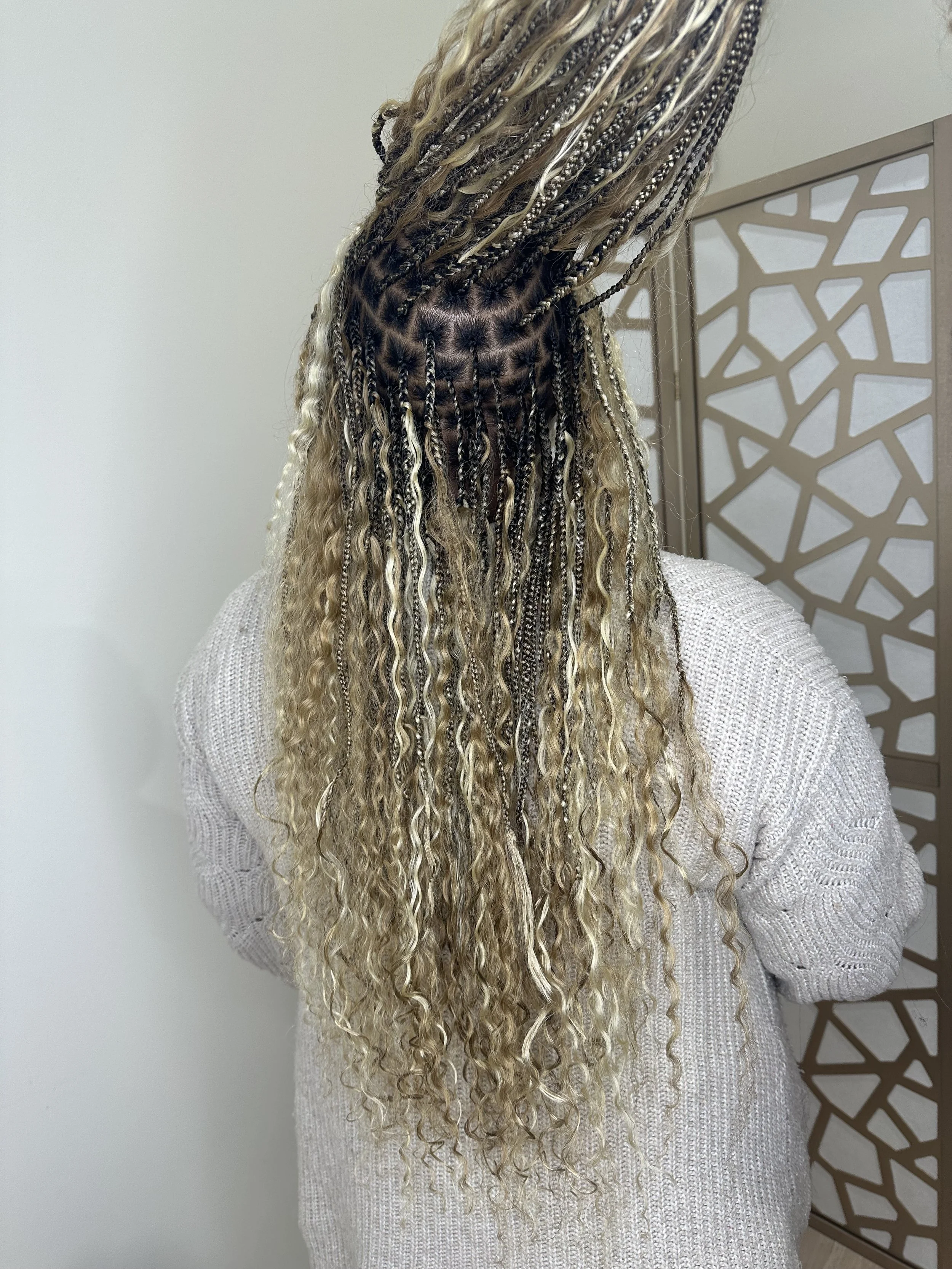 Long blonde boho braids with curly human hair shown from the back at Legacy Braids in McKinney, TX
