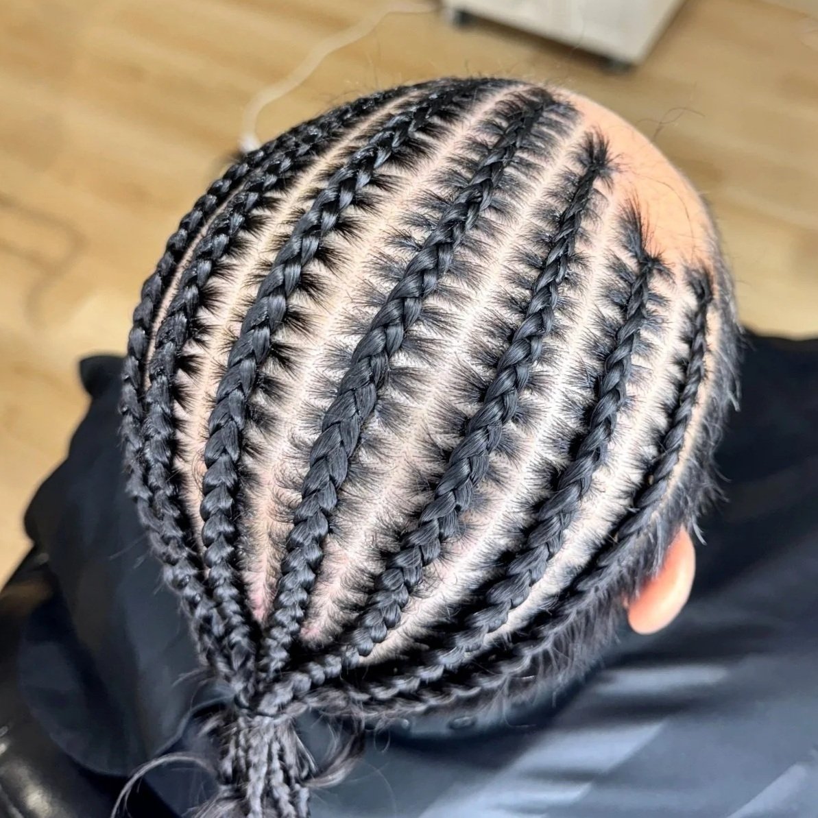 Men’s ten stitch braids with detailed parting and precise stitching