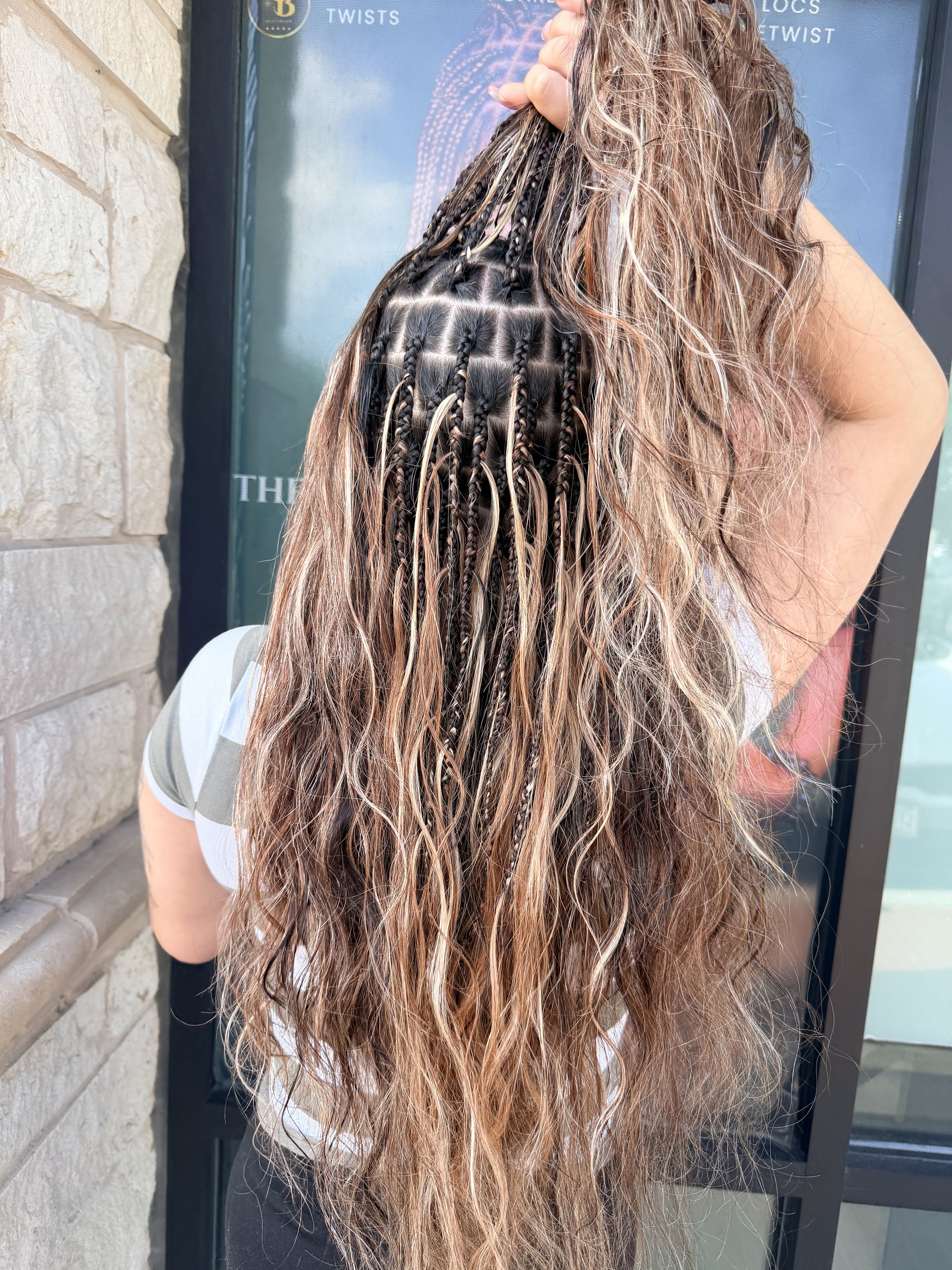 Long blonde and brown boho braids with wavy human hair shown from the back at Legacy Braids in McKinney, TX