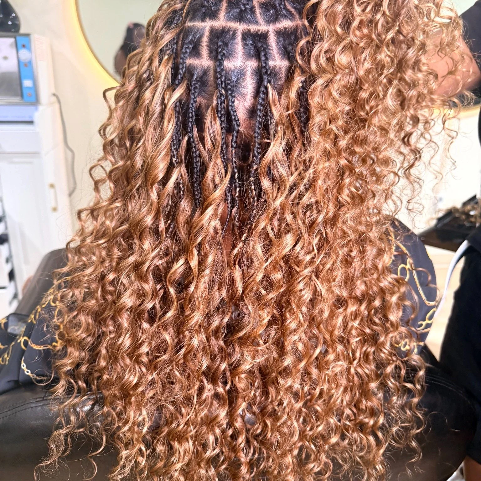 Miracle Knots with copper curly human hair and visible braid foundation at Legacy Braids in McKinney, TX