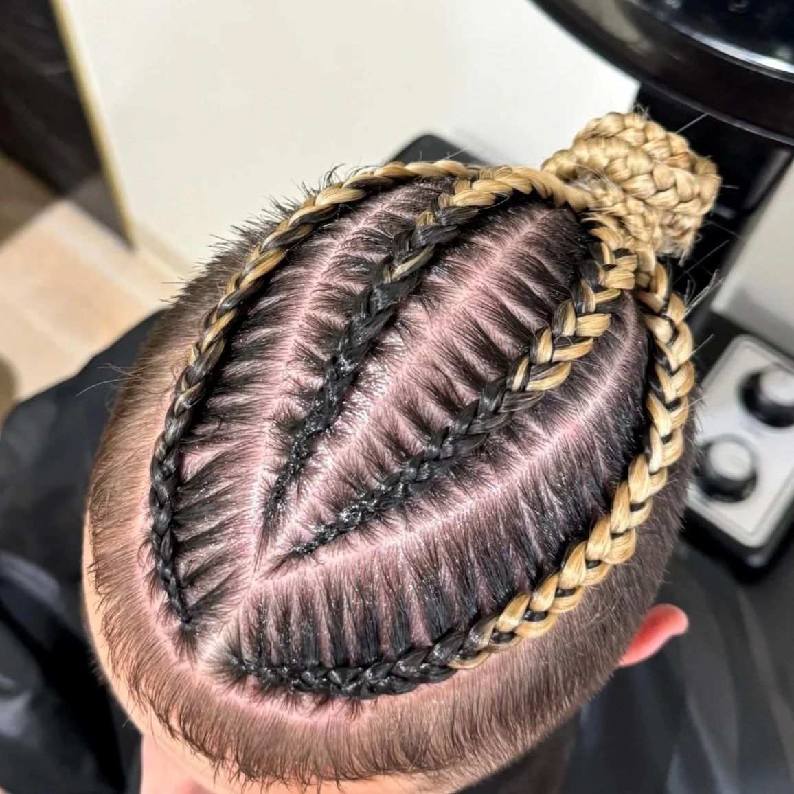 Men’s stitch braids with a custom scalp design and accent braid