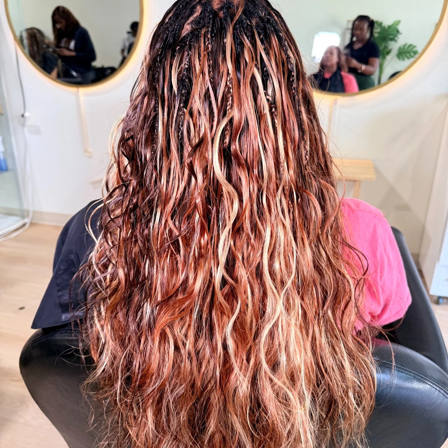 Long brown and copper Miracle Knots with wavy human hair at Legacy Braids in McKinney, TX