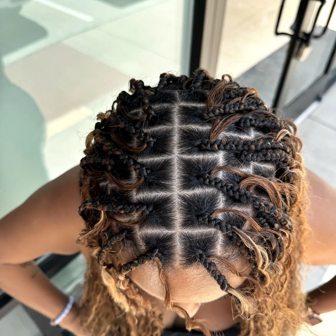 Medium boho braids with clean parting and curly human hair at Legacy Braids in McKinney, TX