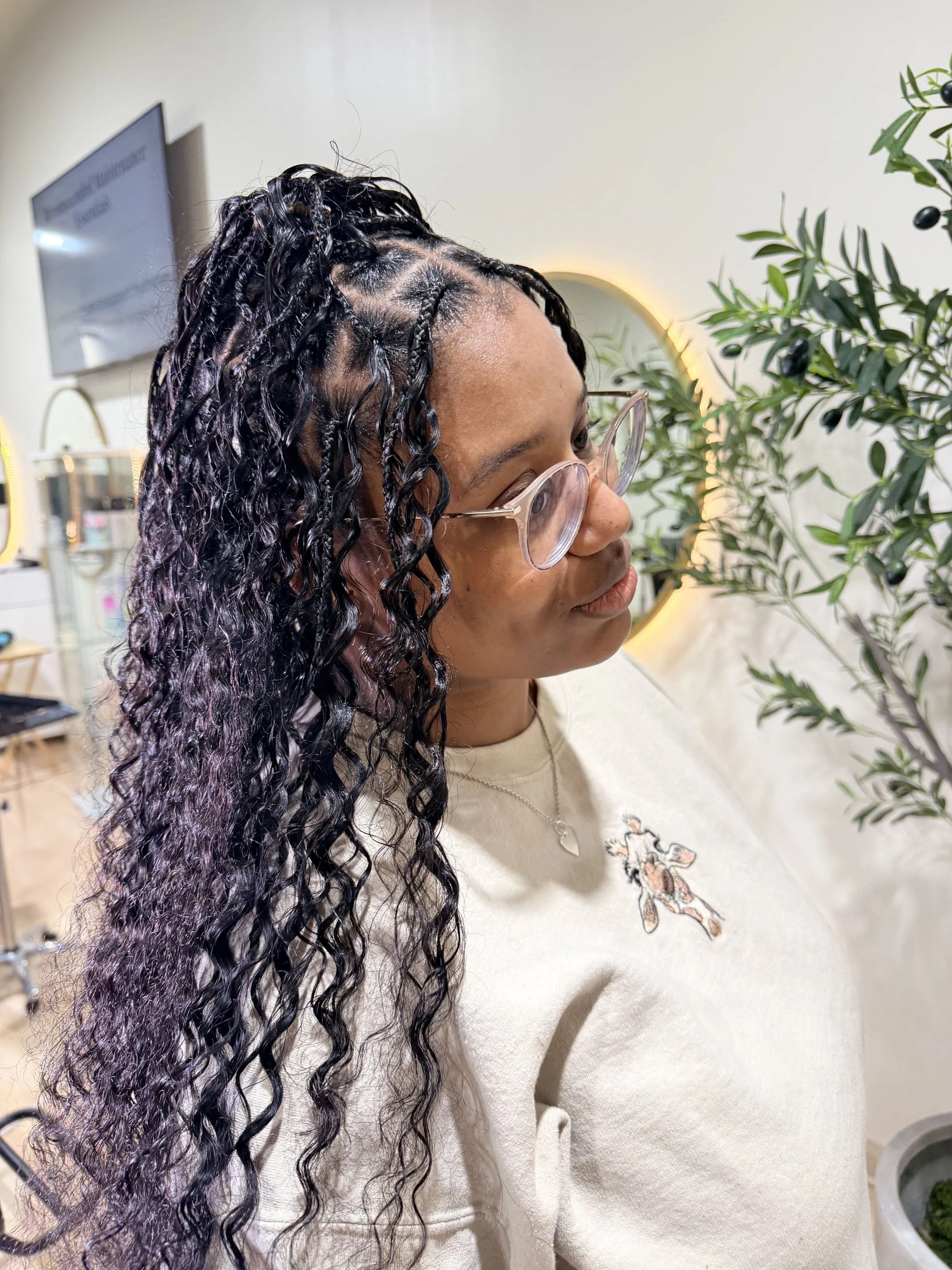 Medium-density Miracle Knots with curly human hair for a lightweight, natural-looking finish at Legacy Braids in McKinney, TX