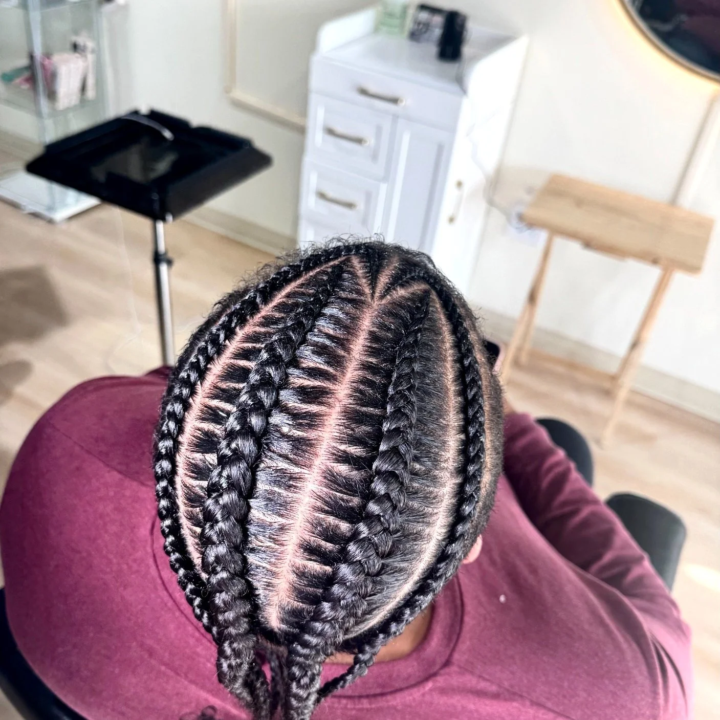 2 Men’s stitch braids with clean curved parting and precise detailing