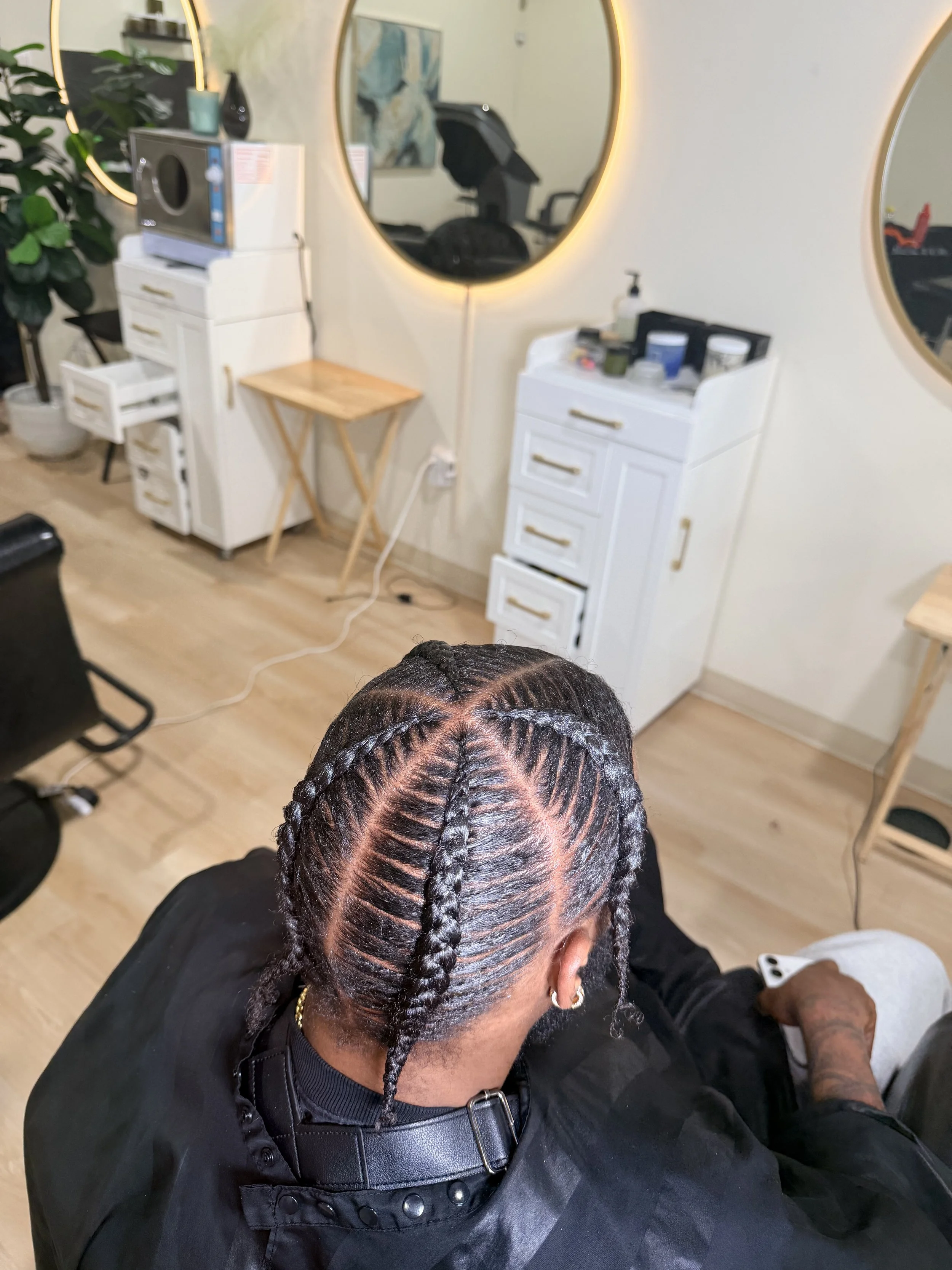 4 Men’s stitch braids with clean curved parting and precise detailing