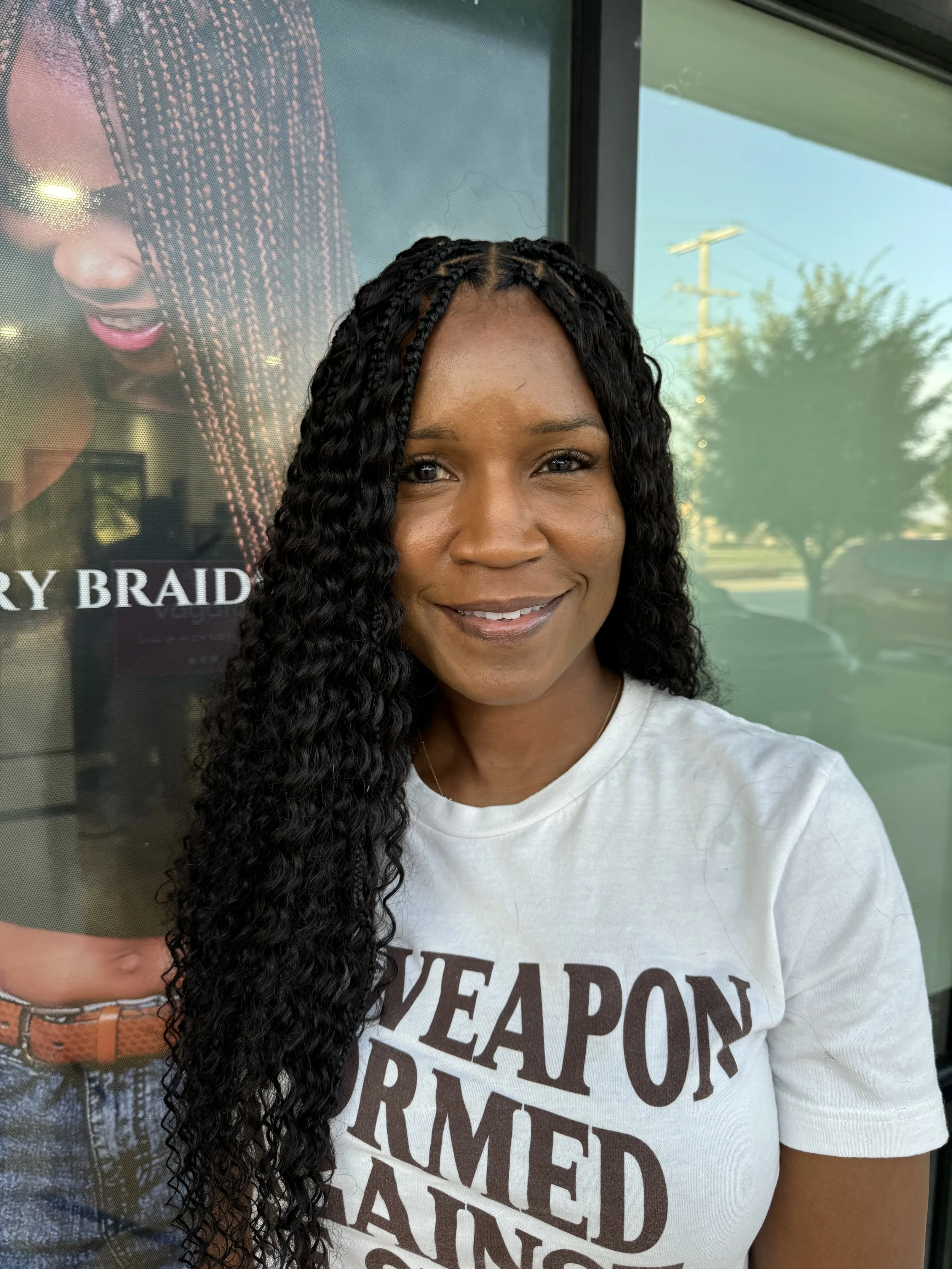 Woman wearing long black boho braids with curly human hair at Legacy Braids in McKinney, TX