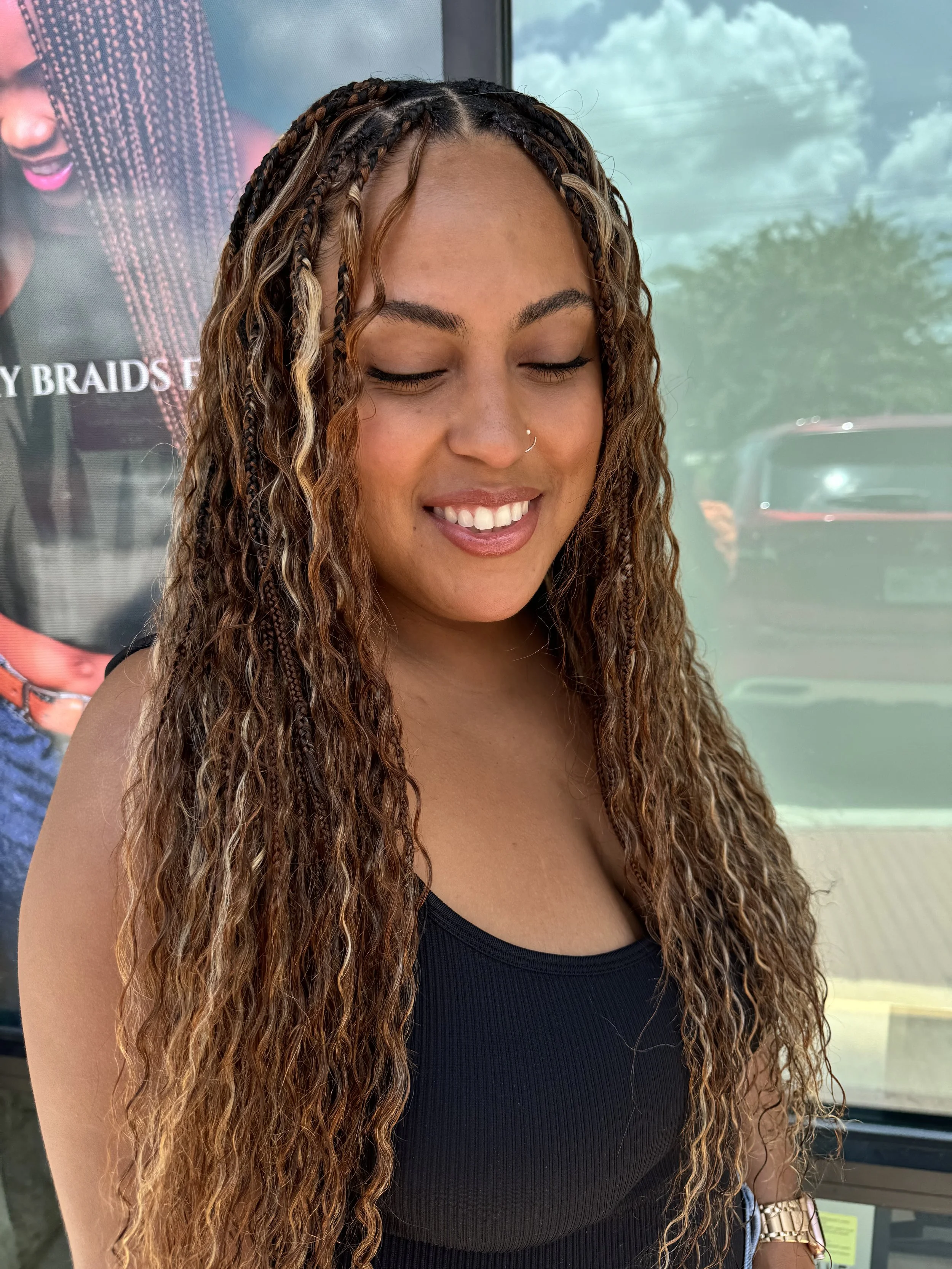 Woman wearing long brown ombre boho braids with curly human hair at Legacy Braids in McKinney, TX