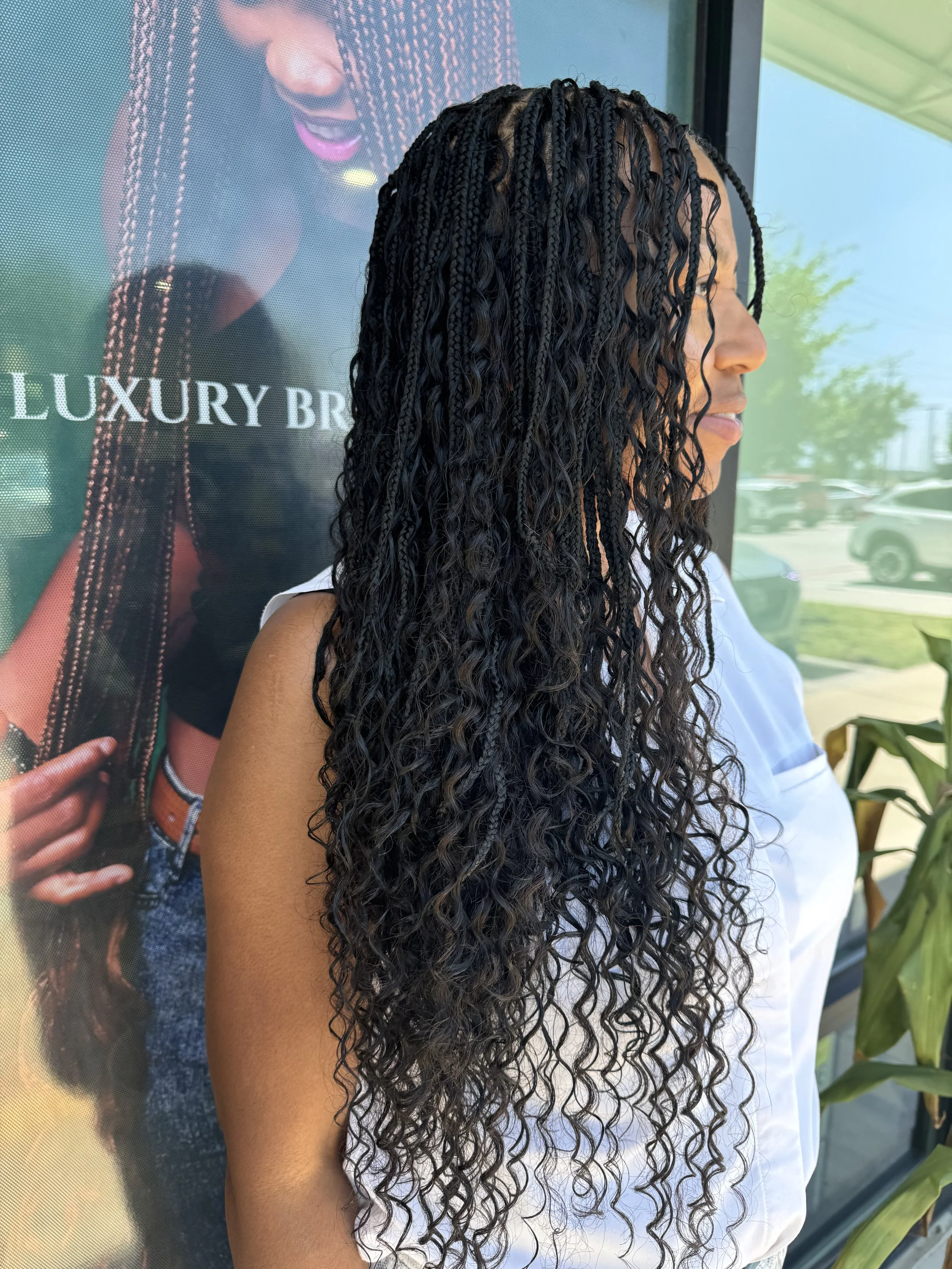 Side view of long black boho braids with curly human hair at Legacy Braids in McKinney, TX