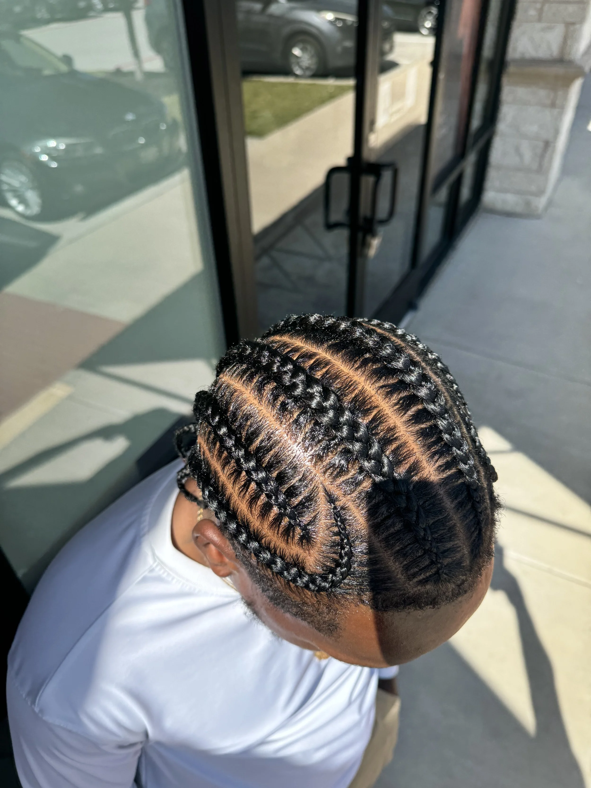6 Men’s stitch braids with clean geometric parting and defined sections