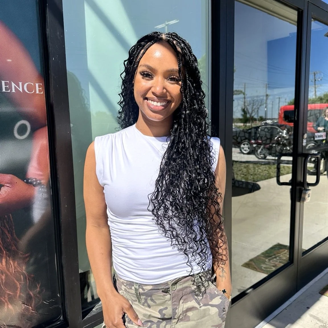 Woman wearing long black boho braids with curly human hair at Legacy Braids in McKinney, TX