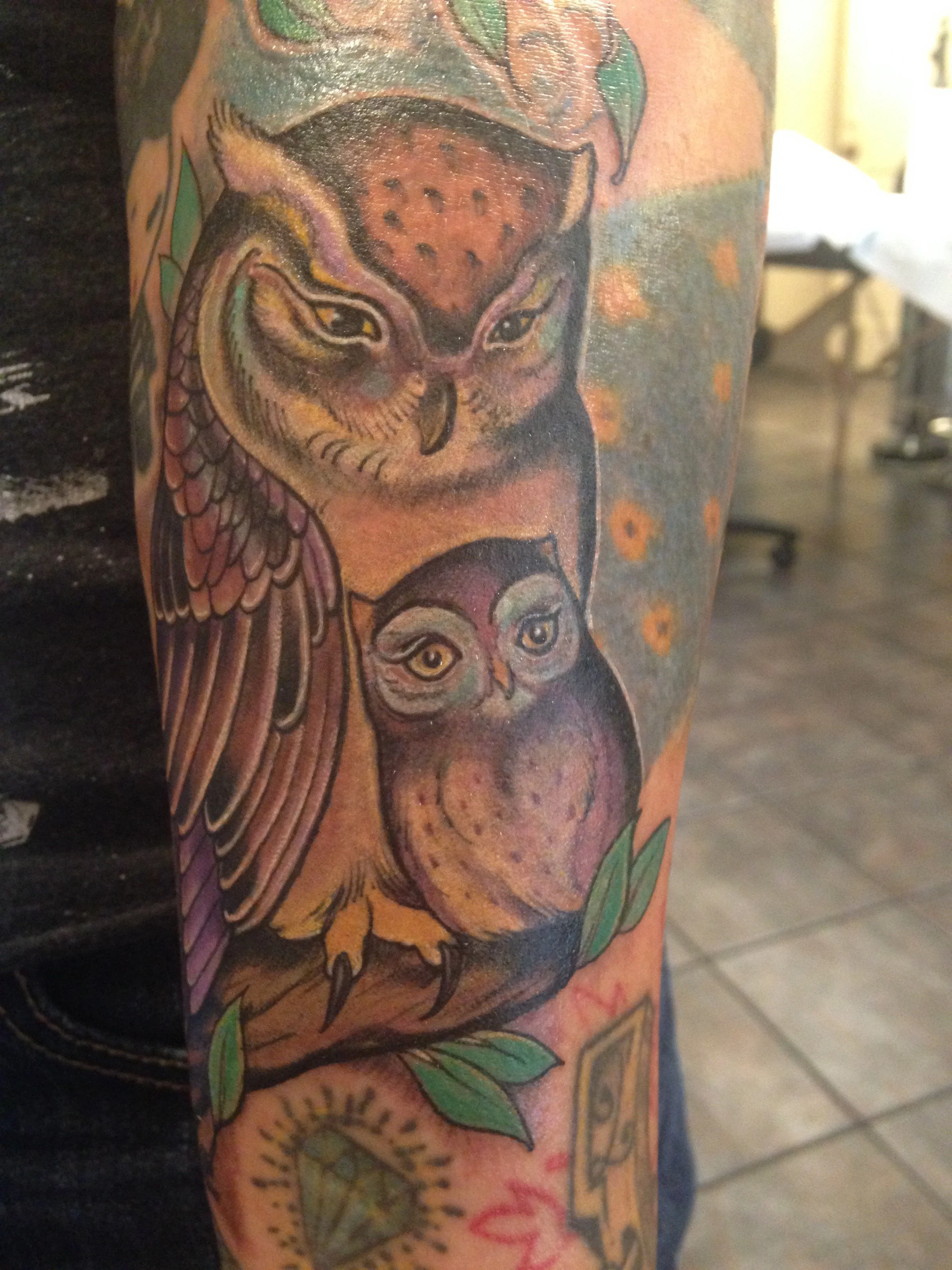 The owner's owl tattoo that she covered after lightening with laser treatments.