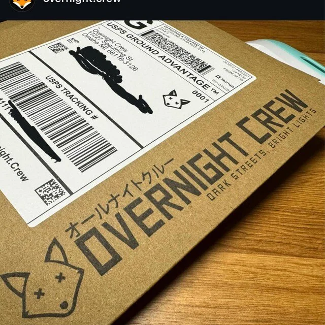 Custom packaging rubber stamp used to brand a kraft cardboard shipping box with business logo