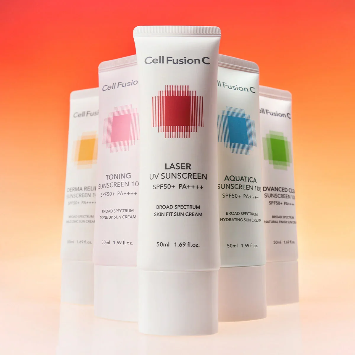 Four tubes of sunscreen with colorful geometric designs and text, set against a gradient pink and orange background.