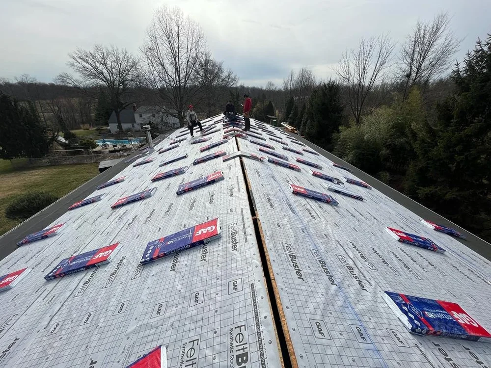 RoofEx roofing project with underlayment and shingle bundles before installation