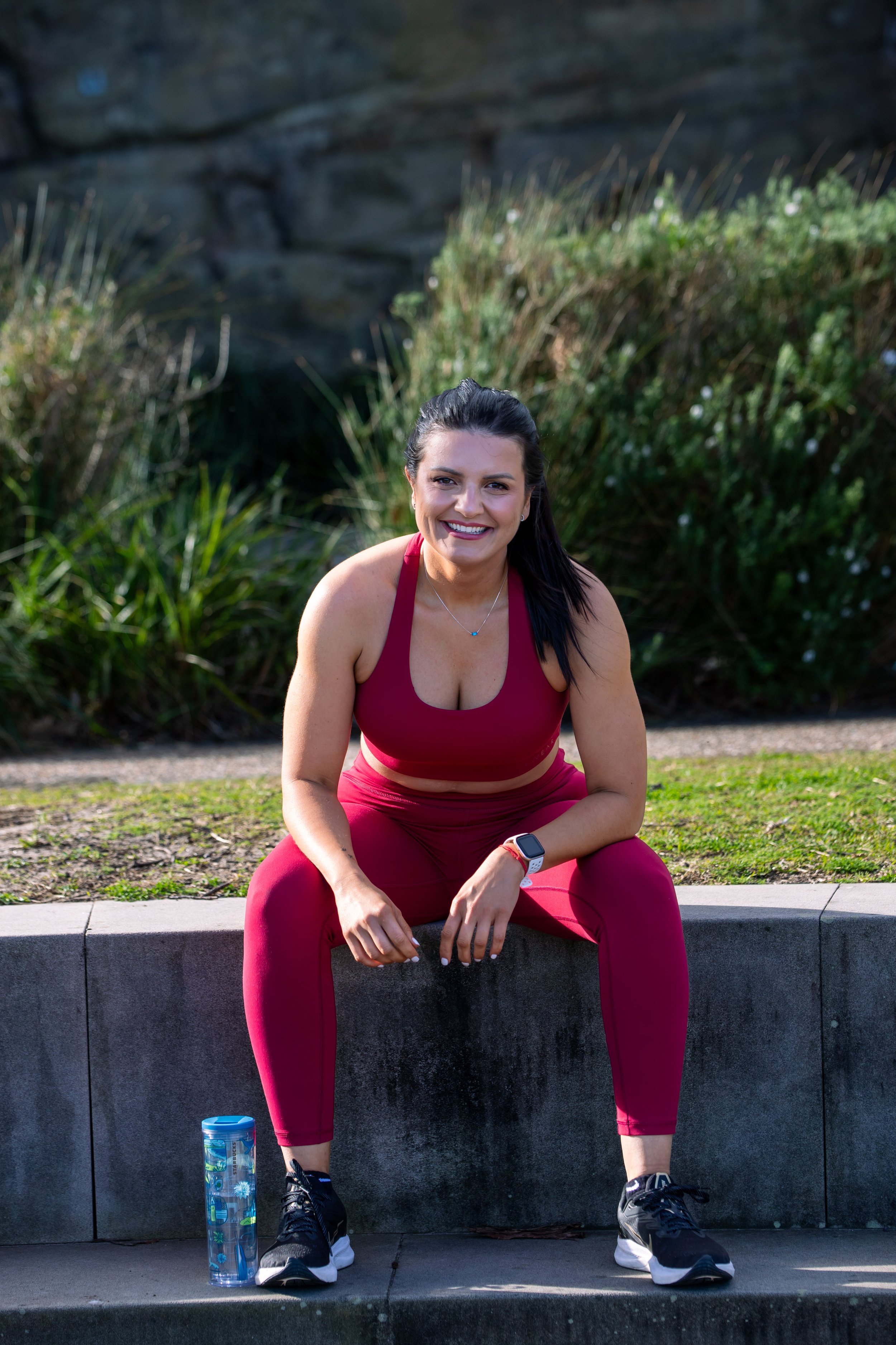 women runner resting near beach in sydney