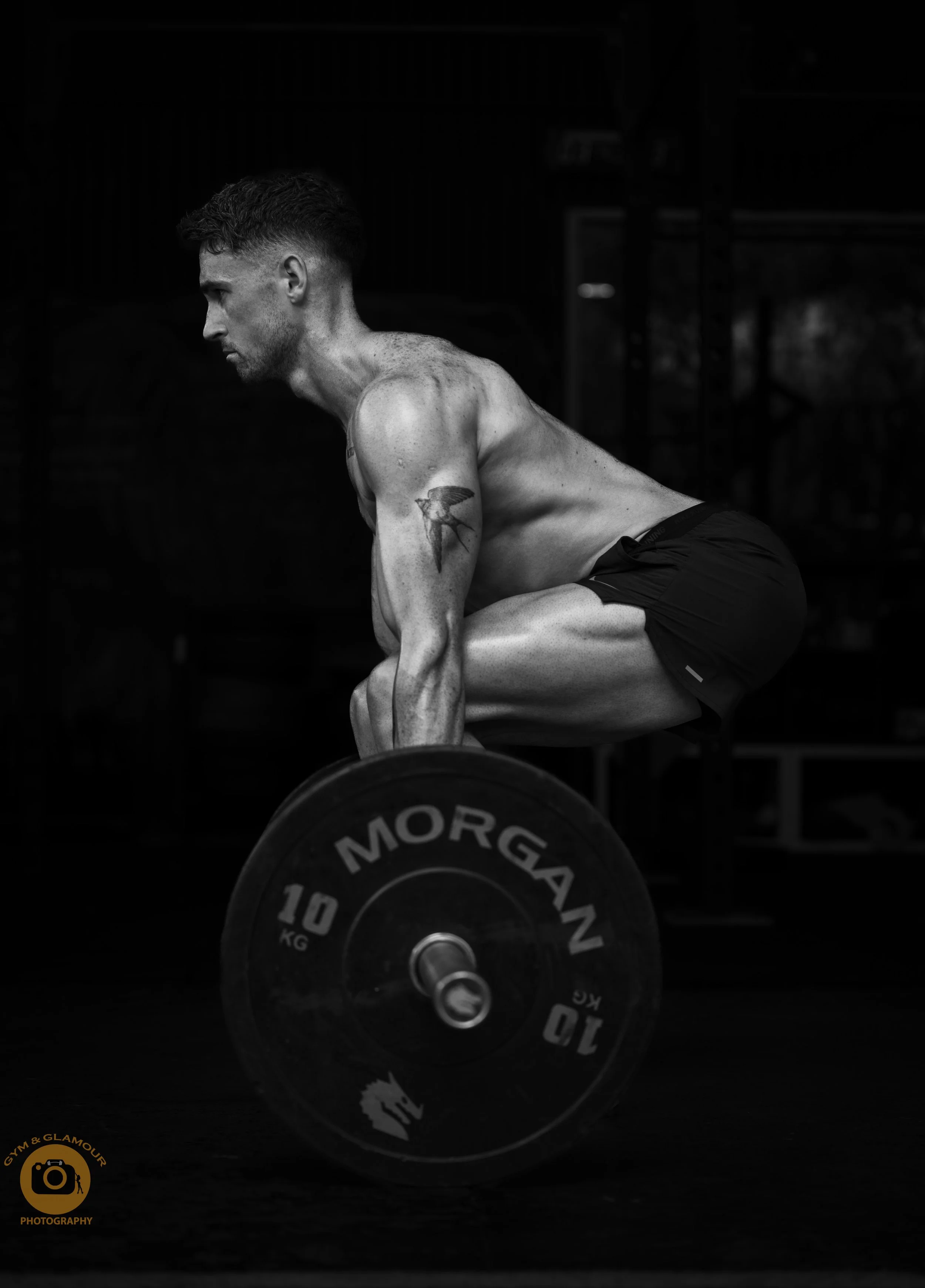 black and white photo of man doing deadlift in a sydney gym