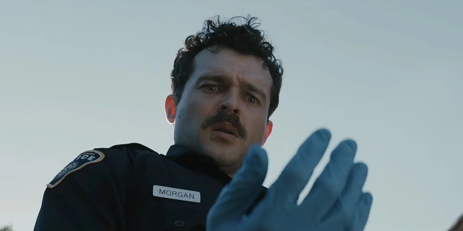 alden-ehrenreich-as-morgan-looking-down-on-his-bloodied-hand-in-the-horror-movie-weapons.jpg