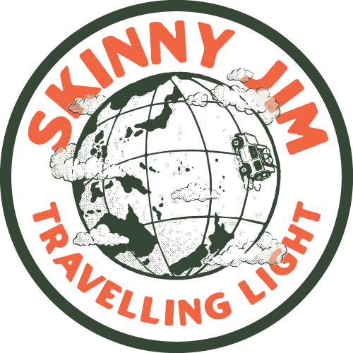 Logo with a black globe surrounded by clouds, with the text "Skinny Jim Traveling Light" in bold red letters around the globe.
