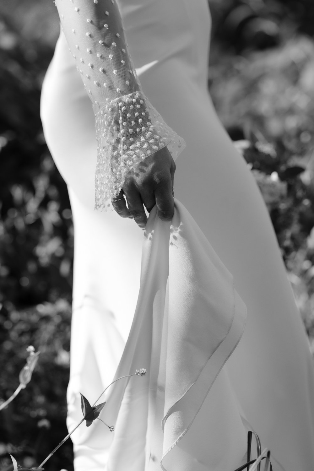Up close detail shot of bride's sleeve cuff with polka dots.