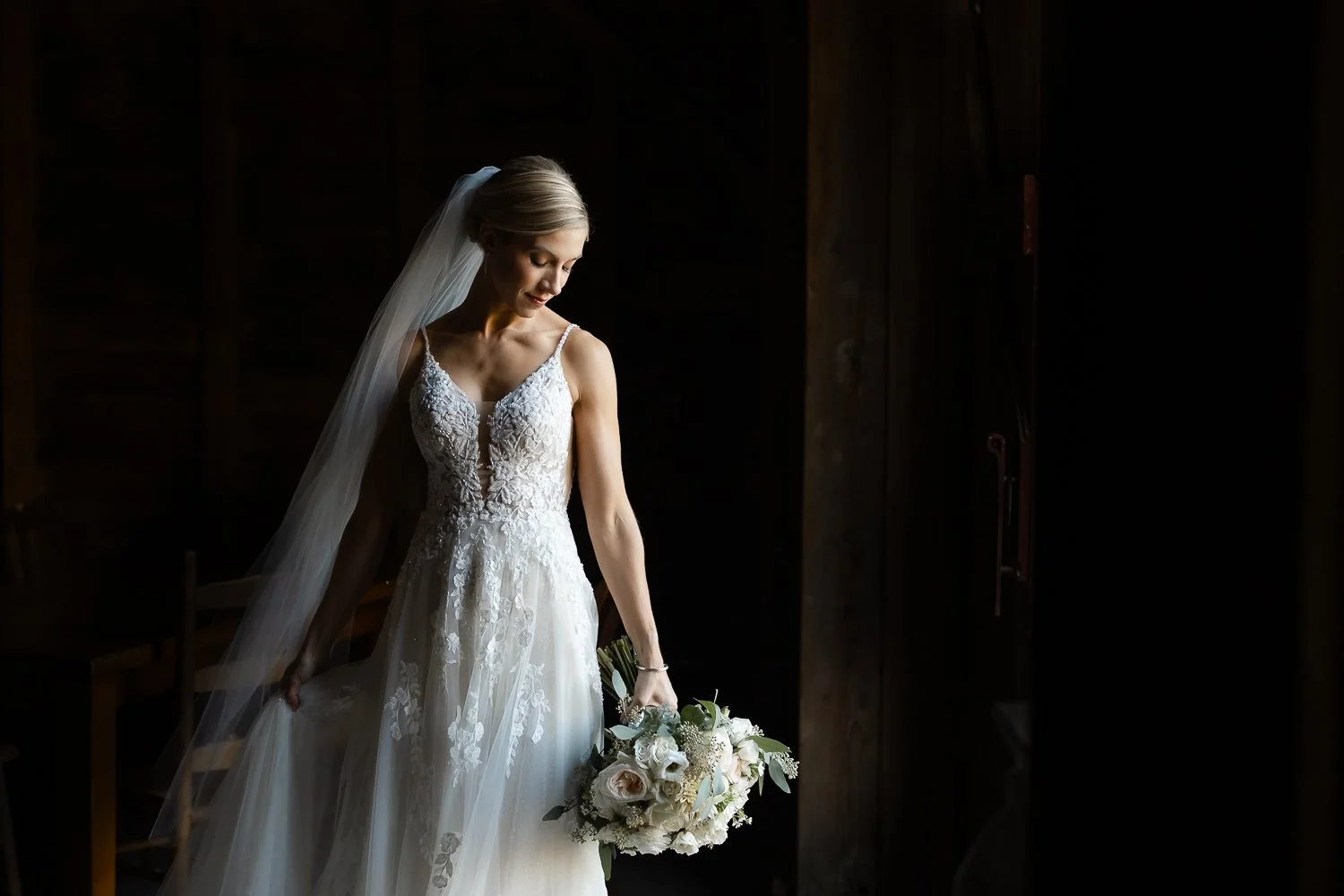 Bride stands in a doorway taking a breath before walking out to her wedding ceremony in NY.