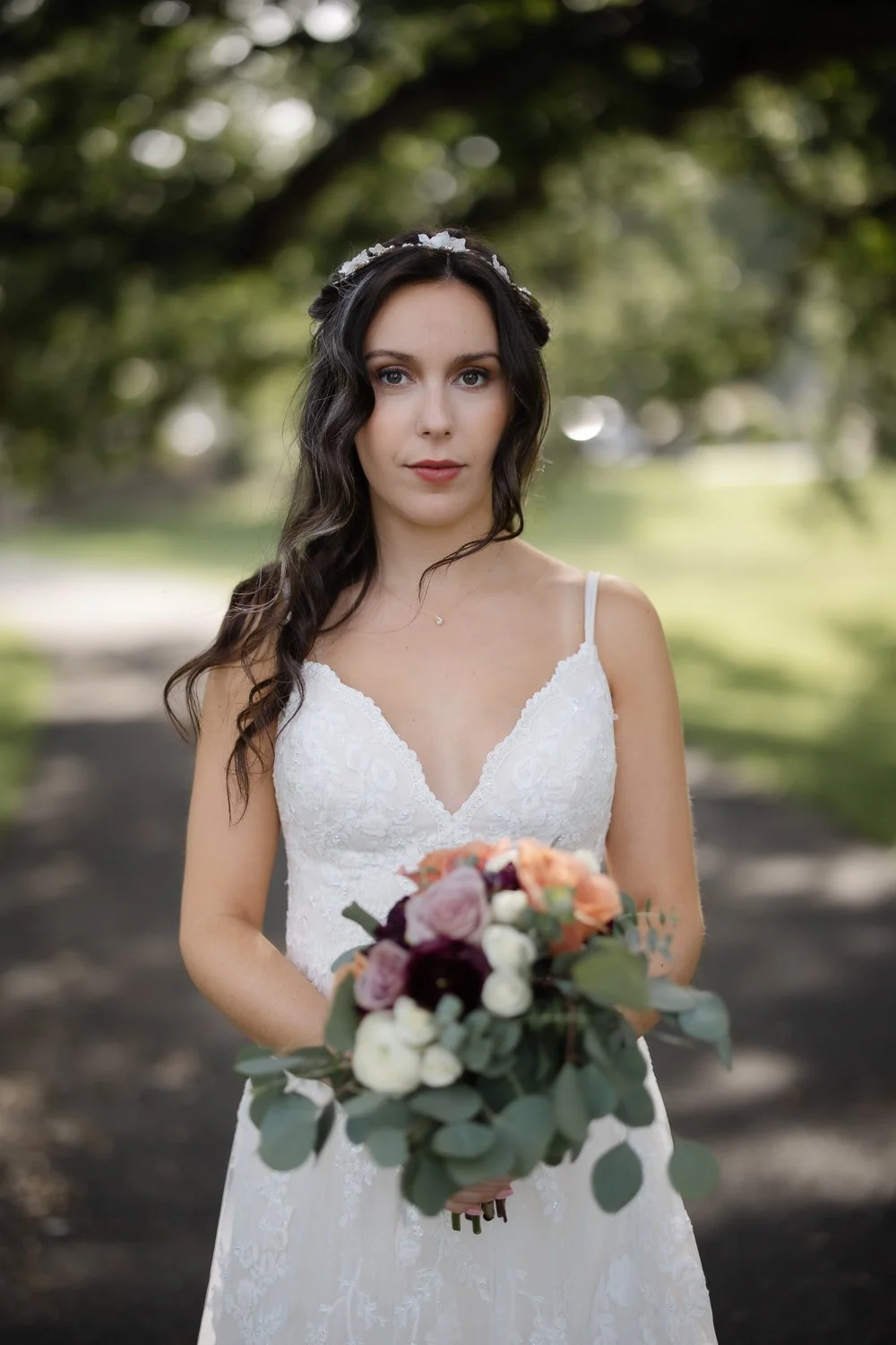 Beautiful bride gives a serene look while herhair is gently blown around her face.