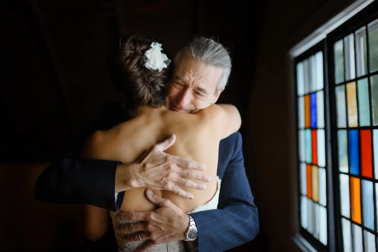 A father holds back tears as he hugs his daughter before her wedding ceremony in the Hudson Valley.