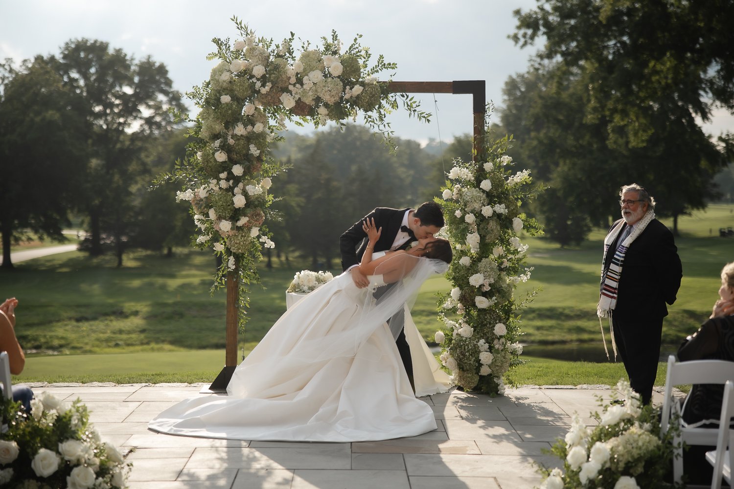 Groom dips his bride at the altar for their first kiss at Upstate NY wedding.