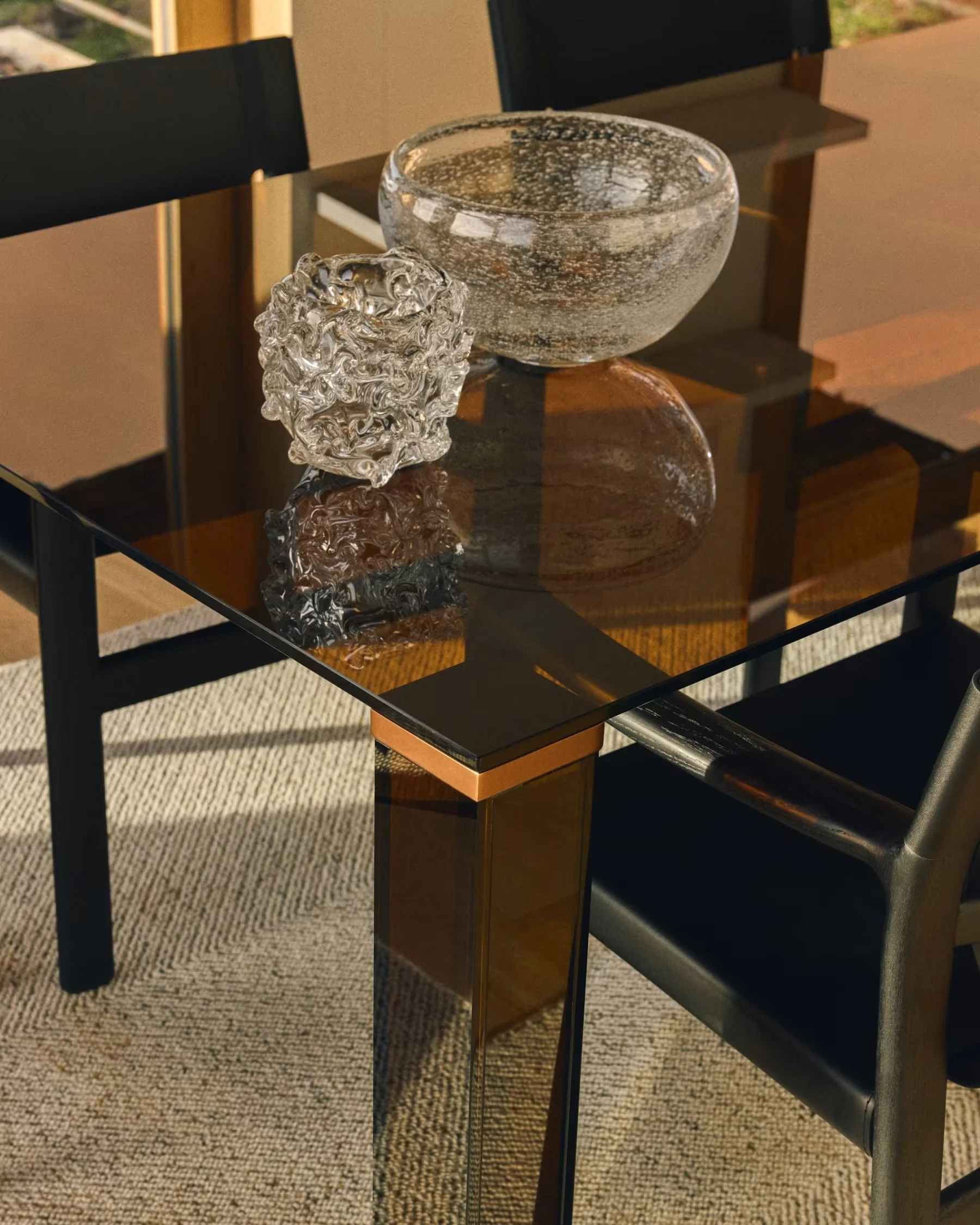 The very stunning Adularia table is a minimalist design of beautiful tempered glass with seamless lines and angles. With the signature aesthetic of 70&rsquo;s mediterranean design, the gorgeous amber brown colour is enhanced by light and elevates a f