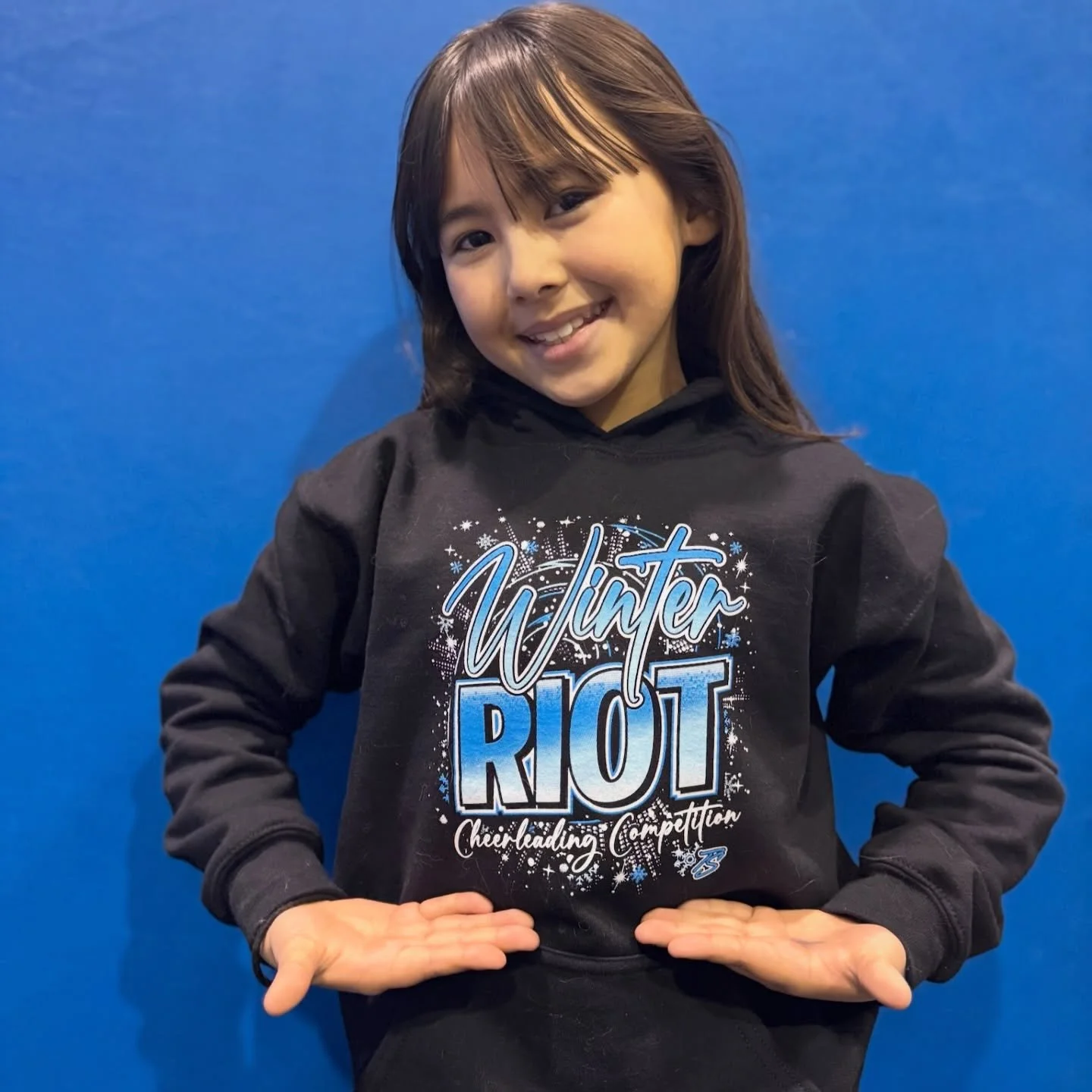 Child posing in event hoody