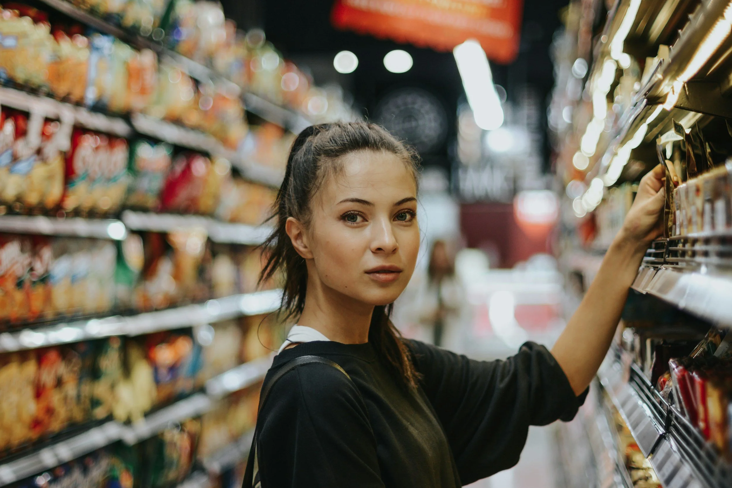 A woman standing a grocery aisle