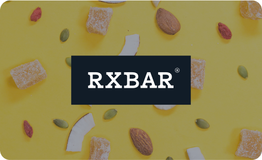 Rxbars on yellow background with assorted nuts and dried fruit