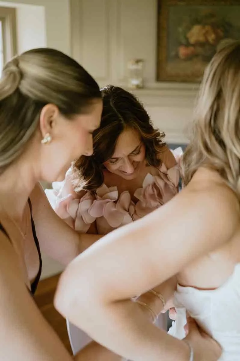bride-putting-on-dress-fox-briar-farm.jpg