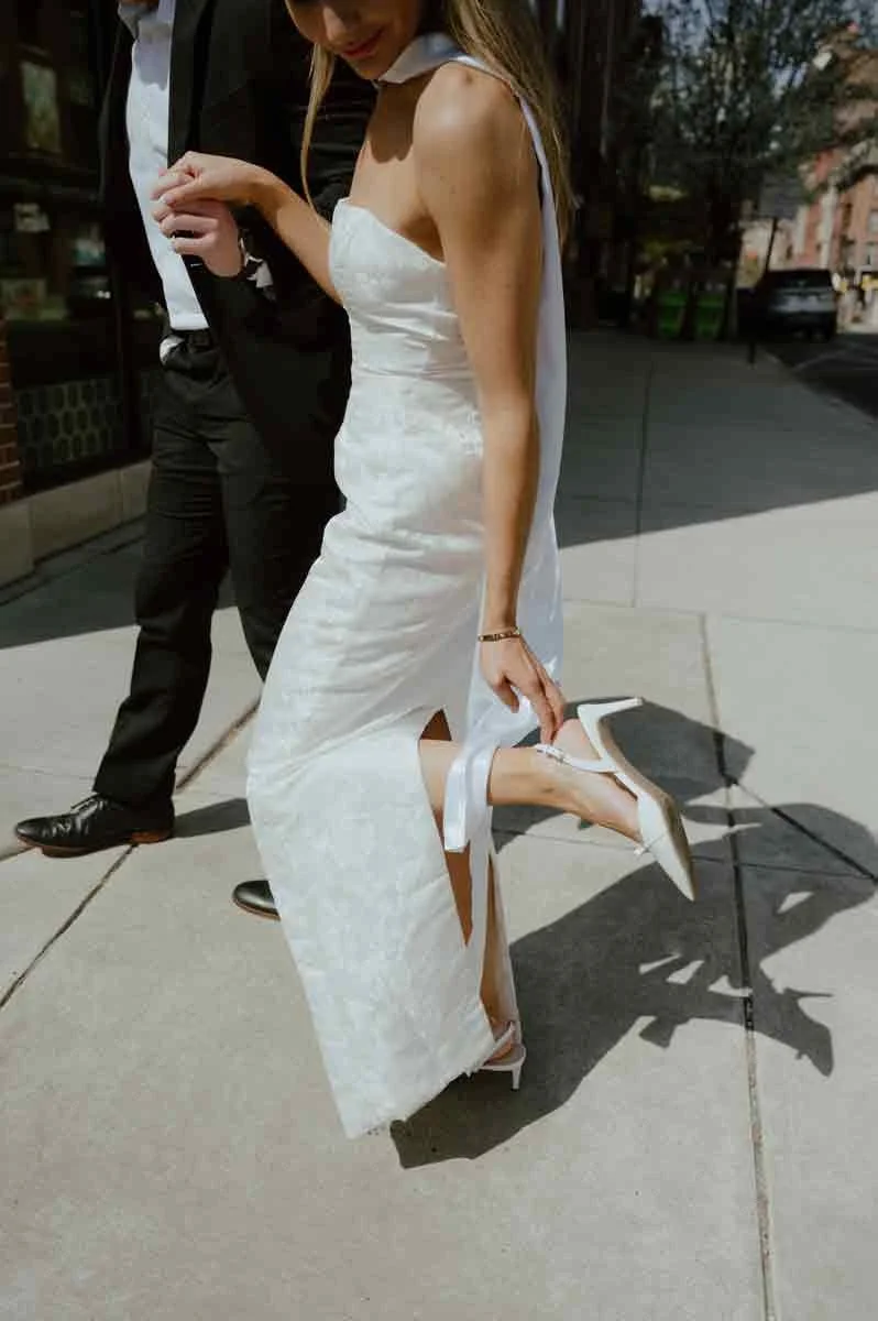 Couple walking through historic Philadelphia streets near Merchants Exchange