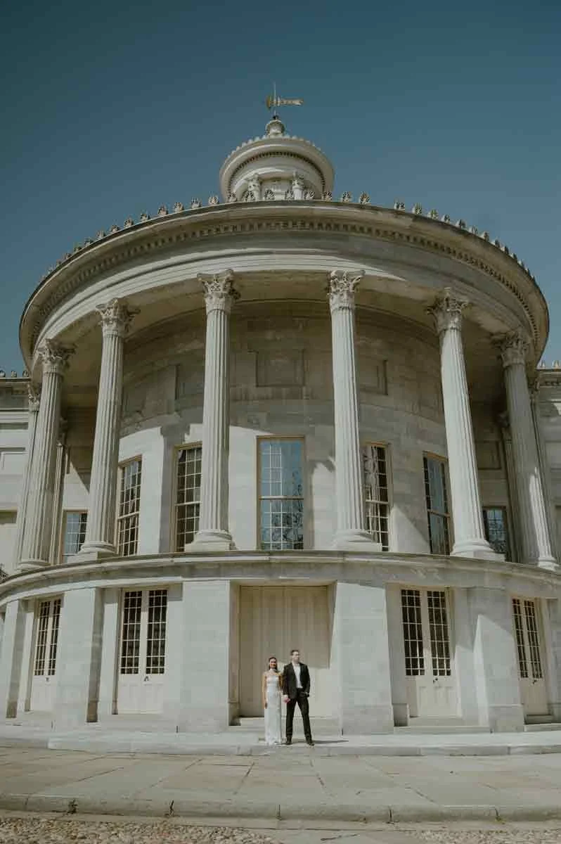Couple posing in front of stone columns at Merchants Exchange Building Old City Philadelphia