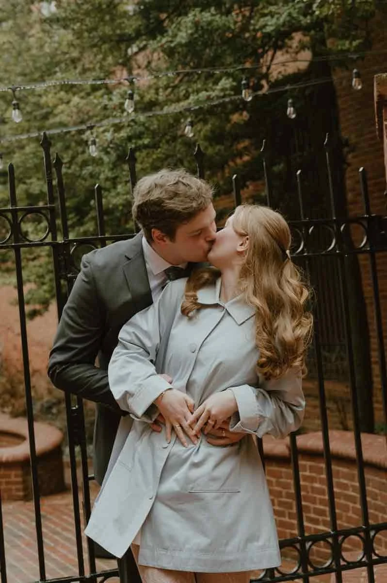 Bride wearing vintage blue raincoat during downtown Lancaster couples photos